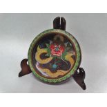 An early 20th century Chinese cloisonne shallow bowl, the interior decorated with a dragon chasing