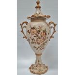 A continental porcelain twin handled vase and cover, gilt decorated with wild roses, height 39cm.