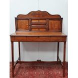 A late 19th century oak and inlaid escritoire, with raised back, fitted cupboards and drawers and