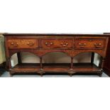A George III style oak pot board dresser base, fitted three drawers above a turned frame, height