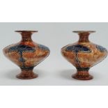 A pair of Royal Doulton stoneware vases with Art Nouveau stylised decoration, height 14.5cm.