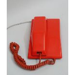 A Contempra orange plastic dial telephone.