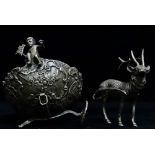 A silver table centrepiece in the form of a reindeer pulling a cart with Rococo decoration, bears