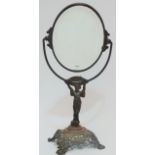 An early 20th century iron framed toilet mirror, fitted an oval bevelled plate, the stem modelled as