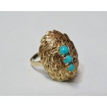 A 9ct gold three stone turquoise ring, decorated with a spiral of stylised laurel leaves, size M,