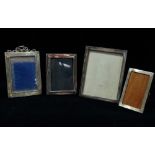 A silver photograph frame, London 1927, height 19cm, together with three other silver photograph