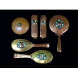 An English Arts & Crafts copper, brass and enamel dressing table set in the manner of The Bromsgrove