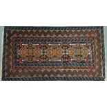 A late 20th century Afghan Baluchi rug, with a navy blue ground and triple geometric lozenge, 196