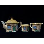 A Sylvac three piece cottage tea set, comprising a teapot, a sugar bowl and a milk jug.