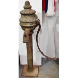 A Victorian cast iron floor standing water pump, with traces of original green paint, the casting