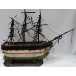 A 19th century naive painted wooden model of a three masted ship on stand, length 26cm, height