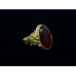 A continental Renaissance style high purity gold carnelian cabochon set ring, the shank with