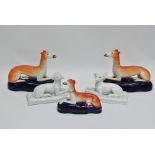 A pair of 19th century Staffordshire recumbant greyhound figures, height 13cm, together with a