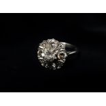 A modern 18ct white gold diamond set nine stone cluster ring, the central diamond of 0.33ct spread
