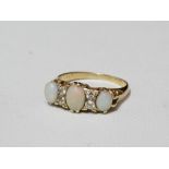 An 18ct gold ring set opals and diamonds, size O.