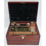 A 19th century rosewood dressing box, with green velvet lining and fitted a removable tray, jars and