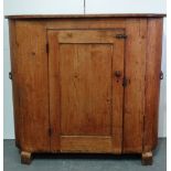 A late 19th/early 20th century pine demi lune shaped larder cupboard fitted a single door, the