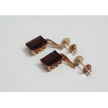 A pair of 9ct gold and garnet drop earrings.