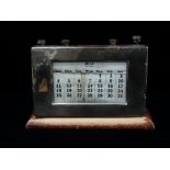 A silver mounted and oak framed perpetual desk calendar, Birmingham 1938, height 14.5cm, width 21cm.