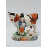 An early 19th century Yorkshire pearlware figure of a farmer with a cow and calf, label to base '