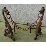 A good pair of Victorian wrought iron country house fire dogs in the form of dragons on scrolling