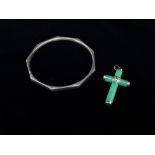 A jade and 14ct gold mounted crucifix, together with a silver faceted bangle.