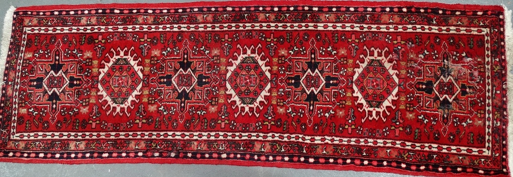 A late 20th century Karaga wool runner with seven medallions, 203 x 65cm.