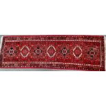 A late 20th century Karaga wool runner with seven medallions, 203 x 65cm.