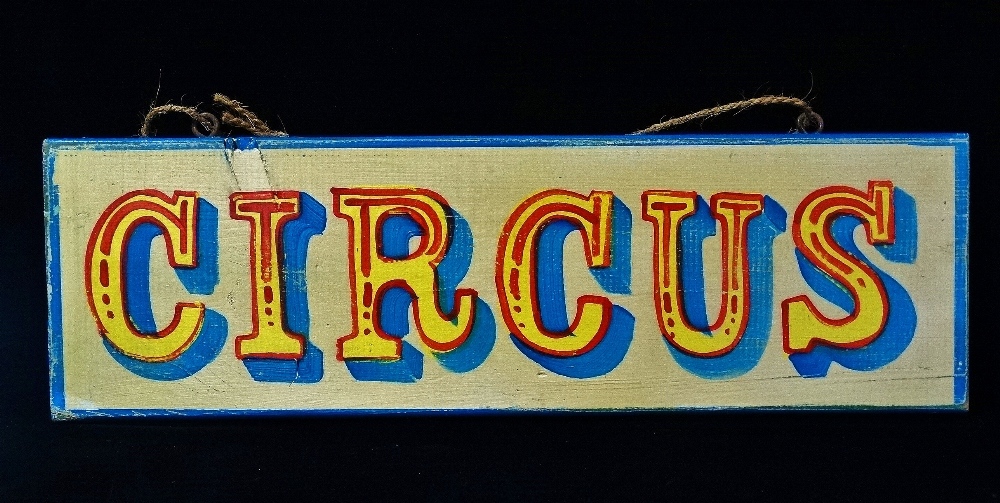 A painted wooden fairground style sign, 'CIRCUS', length 66cm.