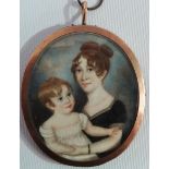 MINIATURE - An early 19th century oval miniature on ivory of a mother and her child in a gold/yellow