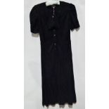 A Jean Muir black crepe de chine dress with subtle striped detail, gathered cap sleeves, front bow
