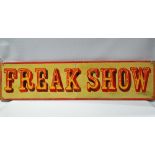 A painted wooden fairground style sign, 'FREAK SHOW', length 123cm.