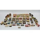 A collection of fifty two 1930s advertising and souvenir metal printed matchbox covers, mainly
