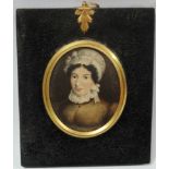 MINIATURE - An early 19th century miniature on card of a lady wearing a bonnet, height 6.5cm.