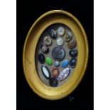 A good collection of eighteen 19th century buttons and covers, framed as one, including enamel,