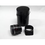 A Leitz Wetzlar Elmarit-R 35mm f2.8 lens in black finish with hood, u.v. filter, rear cap and case.