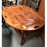 20th century campaign style butlers coffee table - A yew wood and brass folding four handled oval