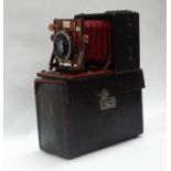A quarter-plate Sanderson hand-and-stand camera, 'Regular Model' in black leather-covered mahogany