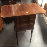 Regency work box - A mahogany drop flap three graduated drawer table on turned legs and castors with