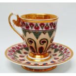 19th century continental hard paste porcelain - A hand painted cup and saucer with gilt and