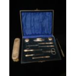 A silver manicure set, Birmingham 1920, associated makers, cased, together with a silver backed