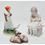 Copenhagen and Bing & Grondahl - A hand painted polychrome figure of a girl with a goose on an