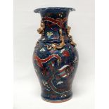 Chinese blue ground vase - A baluster shaped vase gilt and polychrome decorated with dragons chasing