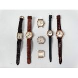 Seven assorted gold plated gentlemans wristwatches, square, circular, tank, some with straps and all