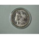 COINS - An 1886 Morgan head dollar.
