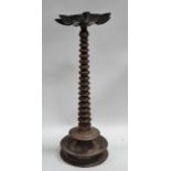 Oriental oil lamp - A seven sectional dish oil lamp with tapering bobbin turned column and flange