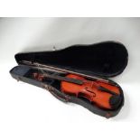 Violin - A circa 1900 four string violin with a two piece back and double stringing inlay, overall