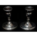 A pair of silver filled candlesticks with engraved decoration on oval shaped bases, Sheffield