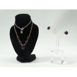 Garnets and amethyst - A silver mounted five cabochon garnet necklace with silver chain, length