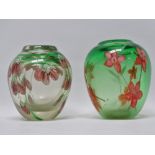 Two bullet shaped green glass vases with integral floral decoration, height 13cm, diameter 11cm.